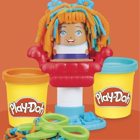 Play-Doh hair styling toy set with girl figure, two tubs in yellow and red, green scissors and moulds, assorted colours