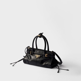 Prada Accessories black mini barrel bag with gold-tone triangle logo hardware, dual top handles and drawstring side details