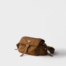 Prada Accessories brown nylon crossbody bag with gold-tone triangle logo, flap front pocket, and adjustable tan leather strap.
