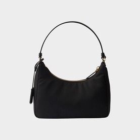 Black nylon shoulder bag with gold-tone hardware, zip closure, slim top handle, and side zip pocket on white background.