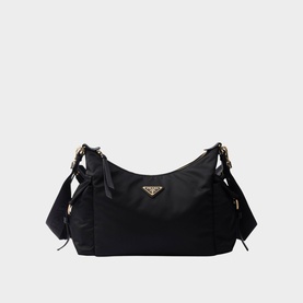 Prada Accessories black nylon shoulder bag with gold triangle logo, side bow details, and adjustable strap