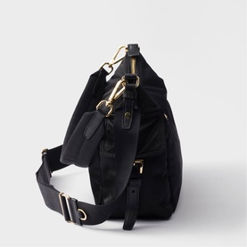 Prada Accessories black nylon shoulder bag with gold-tone hardware, clip fastenings, leather tag, and wide adjustable strap