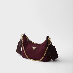 Prada Accessories burgundy nylon mini hobo bag with gold chain strap, triangular logo plaque, and detachable pouch