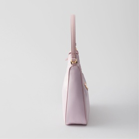 Prada Accessories pink structured handbag, side profile view, gold-tone hardware, short top handle and detachable shoulder strap