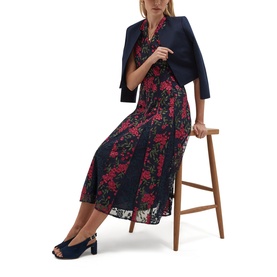 Model wearing Hobbs midnight pink floral lace midi dress, styled with a navy cropped blazer and navy peep-toe heels, seated on a stool.