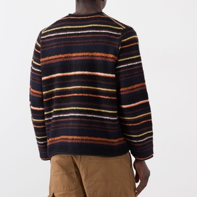 Model wearing SACAI black multi stripe wool cardigan, back view, styled with tan cargo trousers