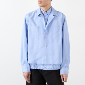 Model wearing Sacai light blue stripe cotton casual shirt with layered collar detail, styled with black trousers