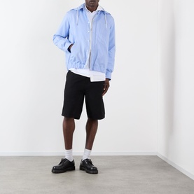 Model wearing Sacai L/Blue Stripe hoodie jacket with black shorts, white shirt, and black leather shoes.