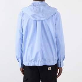 Model wearing SACAI light blue stripe cotton-blend hoodie, rear view, with black trousers featuring Carhartt logo waistband.