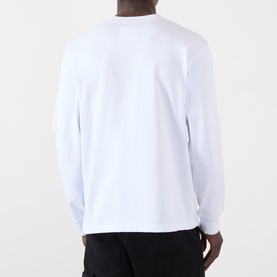 Model wearing SACAI white long-sleeve cotton T-shirt, seen from the back, with black trousers.