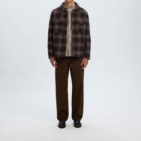 Model wearing Selected Casual Jacket in Delicioso Navy/Grey check, styled with neutral shirt, brown trousers and black shoes.