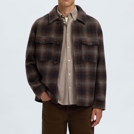 Model wearing Selected Casual Jacket in Delicioso Navy/Grey plaid check, styled over a beige shirt with dark trousers