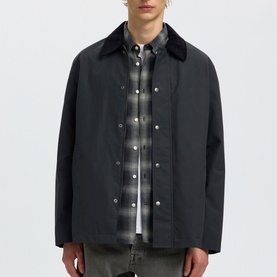 Model wearing Selected Dark Shadow casual jacket with corduroy collar, styled with grey check shirt and grey jeans.