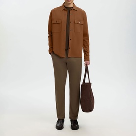 Model wearing Selected toffee casual overshirt with chest pockets, styled with khaki trousers and black loafers, carrying a dark tote bag