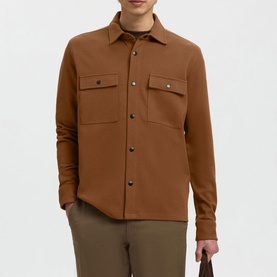 Model wearing Selected Casual Shirt in toffee, featuring chest flap pockets and snap button fastening, styled with khaki trousers