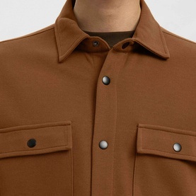 Model wearing Selected Toffee casual shirt, close-up of snap-button placket and twin chest flap pockets