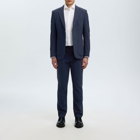 Model wearing Selected dark navy suit jacket and matching trousers, styled with white shirt and black leather shoes