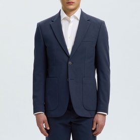Model wearing Selected dark navy suit jacket, two-button single-breasted, styled with white shirt and matching trousers