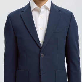 Model wearing Selected Dark Navy suit jacket, two-button single-breasted, notch lapel, styled with white dress shirt