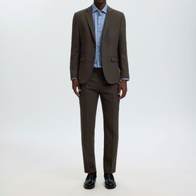 Model wearing Selected Neil Slim Suit Trousers in Delicioso brown, styled with matching suit jacket, blue shirt and black shoes.