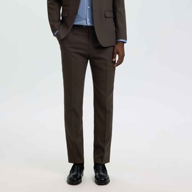 Model wearing Selected Neil Slim Suit Trousers in Delicioso brown, styled with matching suit jacket, blue shirt and black leather shoes.