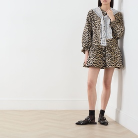 Model wearing Sister Jane multi leopard print mini dress with lace collar detail, styled with black loafers and socks