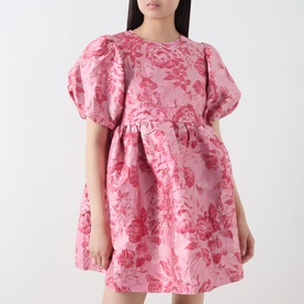 Model wearing Sister Jane pink floral jacquard mini dress with voluminous puff sleeves and gathered skirt detail.