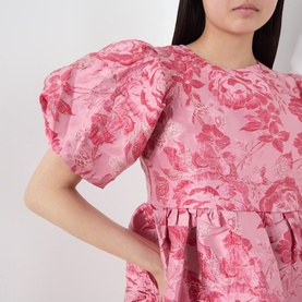Model wearing Sister Jane pink floral jacquard dress with puff sleeves and gathered waist detail