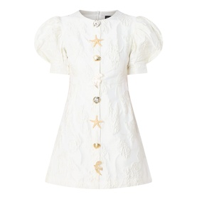 Sister Jane Milos Brooches Mini Dress in white jacquard with puff sleeves, round neckline and gold star and moon embellished buttons