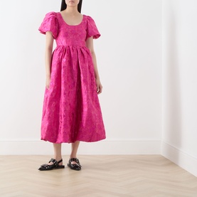 Model wearing Sister Jane pink jacquard midi dress with puff sleeves and full skirt, styled with black patent Mary Jane flats