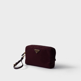 Prada Accessories burgundy nylon cosmetics pouch with gold triangle logo plaque and detachable wrist strap.
