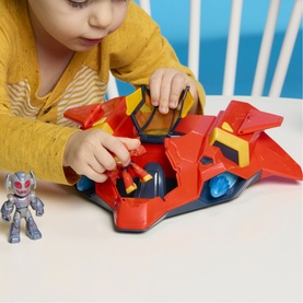 Child playing with Superheroes red and blue spacecraft toy and small robot action figure on a white table