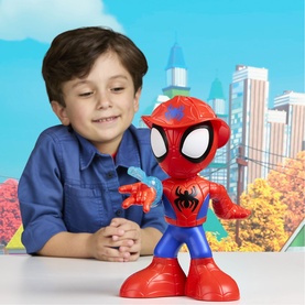 Young boy posing with Superheroes large Spider-Man articulated figure in red and blue, with cityscape backdrop