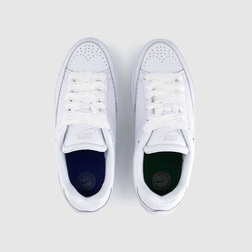 Nike white leather low-top trainers with white laces and purple insole, overhead flat-lay view showing both shoes paired together.