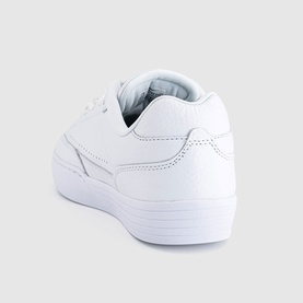 Nike low-top trainer in white leather, rear three-quarter view showing padded collar and clean white sole.
