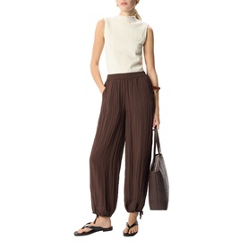 Model wearing Whistles cream sleeveless ribbed top with brown wide-leg pleated trousers, styled with black sandals and a brown tote bag.