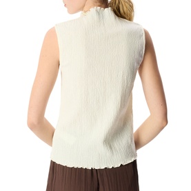 Model wearing Whistles cream sleeveless textured top with lettuce-edge hem, styled with dark brown wide-leg trousers, rear view.