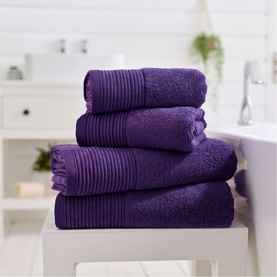 The Lyndon Company Violet plain towel set, five-piece stack including bath sheets and hand towels with ribbed border detail, styled in a bathroom