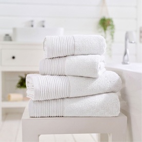 The Lyndon Company white plain towels stacked in four sizes, ribbed border detail, styled in a bright bathroom setting