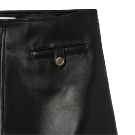 Claude Pierlot black faux leather mini skirt with gold-tone snap button detail and belt loop trim, close-up view