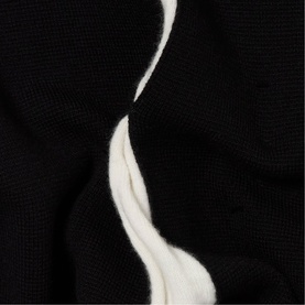Claude Pierlot black knit fabric close-up showing white wavy contrast trim detail on textured woven surface.