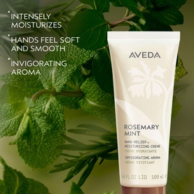 Aveda Rosemary Mint Hand Relief&trade; Moisturizing Cr&egrave;me tube in white and green packaging, styled with fresh mint leaves background
