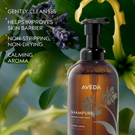 Aveda Shampure Calming Foaming Hand Wash pump bottle with botanical ingredients including lavender and lime visible in background
