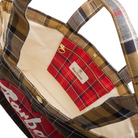 Barbour multi tartan tote bag interior showing cream lining, red tartan zip pocket with gold zip, and script logo detail