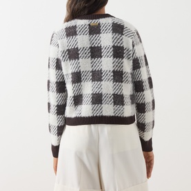 Model wearing Barbour International multi check cardigan, back view, styled with white wide-leg trousers. Dark trim ribbed hem and cuffs.