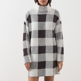 Model wearing Barbour International multi check knit dress in black and white oversized gingham, long sleeves, roll neck, mini length.