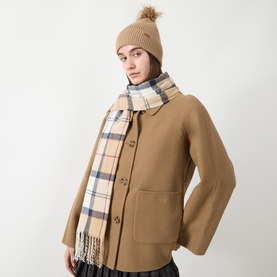 Model with Barbour Dover Beanie Hat & Scarf Gift Set in multi; ribbed pom-pom beanie and tartan tasselled scarf, styled with a camel coat