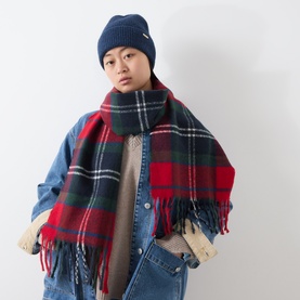 Model with Barbour Olivia Beanie Hat & Scarf Gift Set in multi; navy beanie with logo plaque, red tartan check fringed scarf, styled with denim jacket