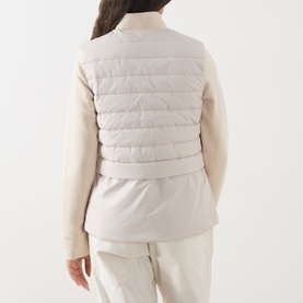 Model wearing Barbour International Ari Hybrid Quilted Jacket in Moonbeam, back view showing quilted padded bodice and contrasting sweatshirt-style