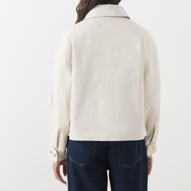 Model wearing Barbour International Moonbeam jacket, back view, with dark navy jeans. Cropped fit, spread collar, long sleeves.
